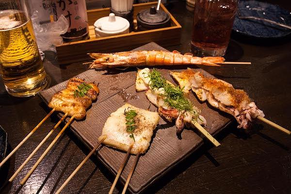 Delicious yakitori sticks on ceramic plate