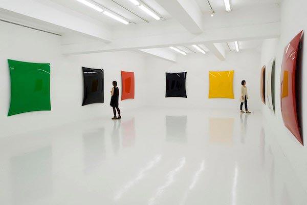 Modern art gallery in Tokyo with large block color sculptural art pieces hanging on walls