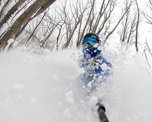 Riding powder stashes at Madarao Mountain in the trees. Japow is epic.